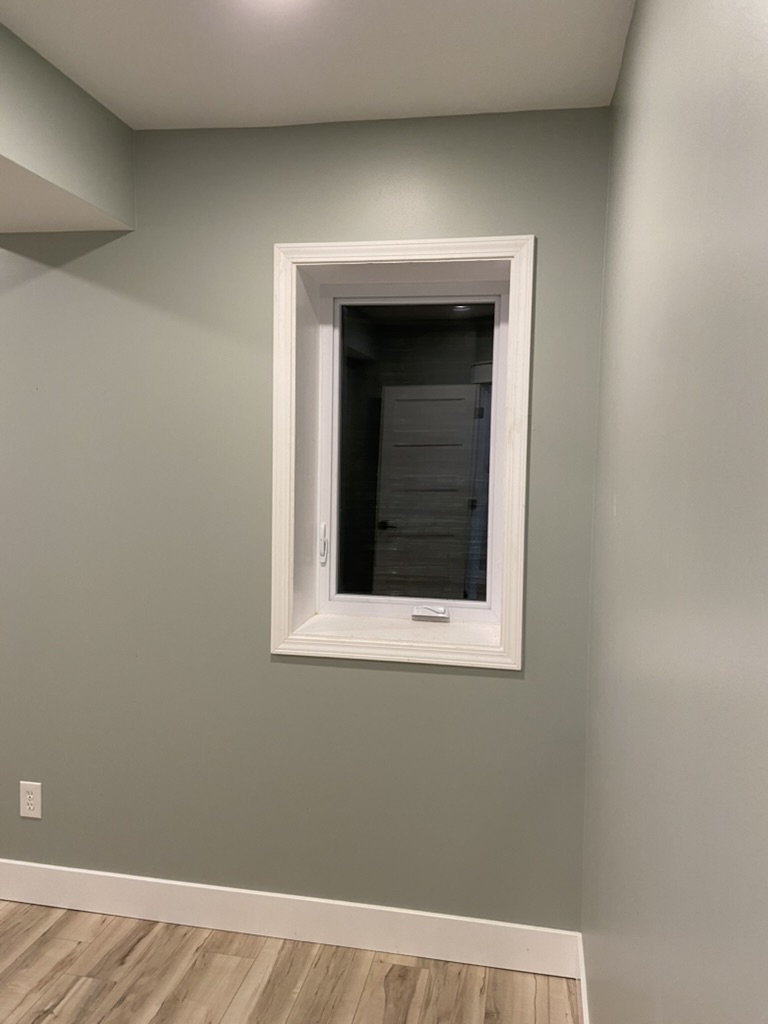 Finished interior view of a casement egress window installed in a basement bedroom in Edwardsville, Illinois, by GHR Egress Windows.