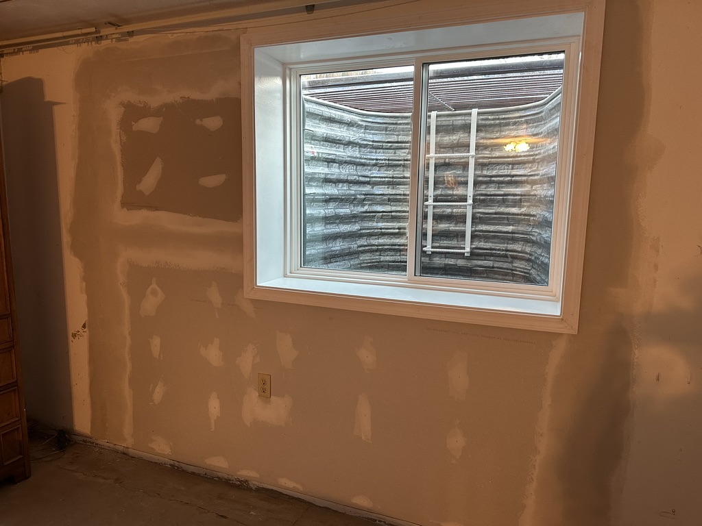 Custom wide egress window with stone print steel well, St. Louis County MO, installed by GHR Egress Windows.