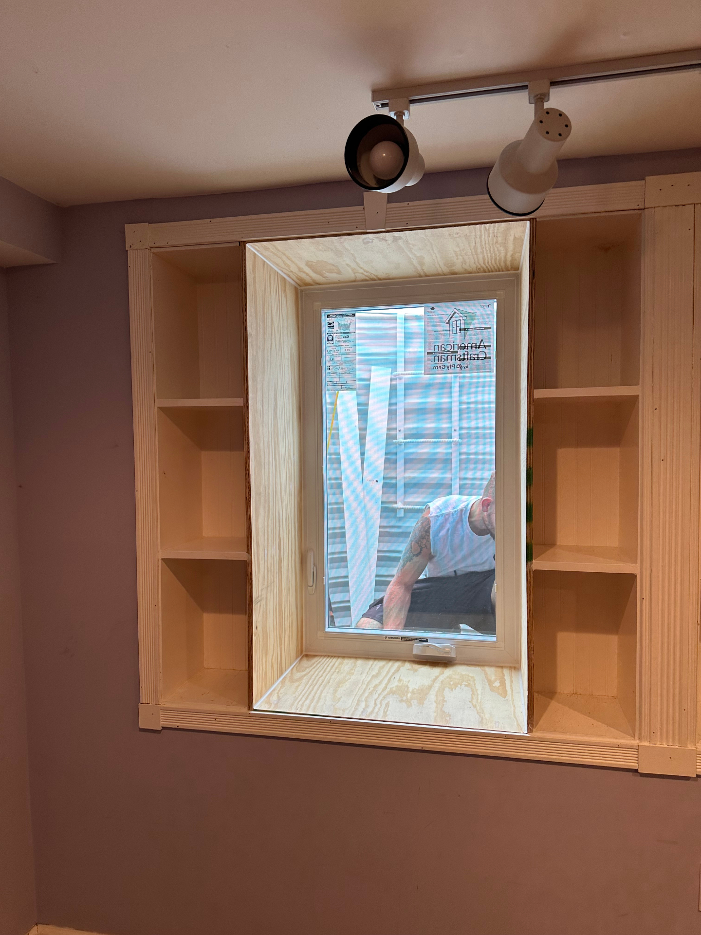 Custom egress window installation framed into existing basement shelving, casement window, by GHR Egress Windows.